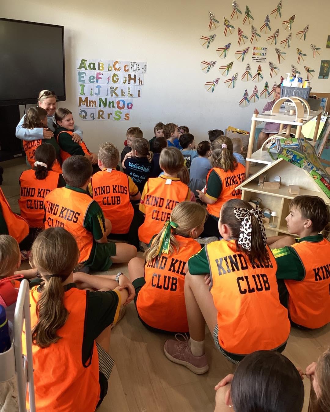 Children learning about kindness and community awareness during group discussion