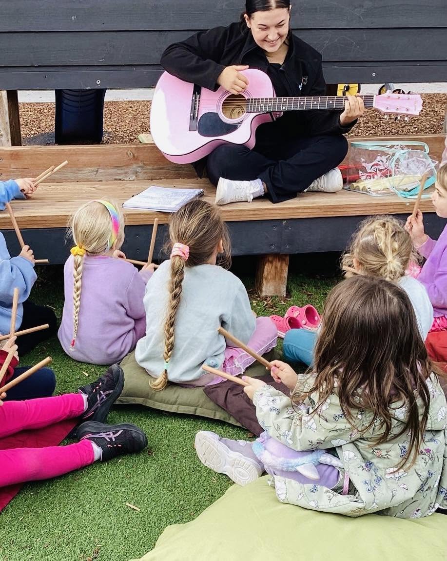 Babies participating in music activities with an educator