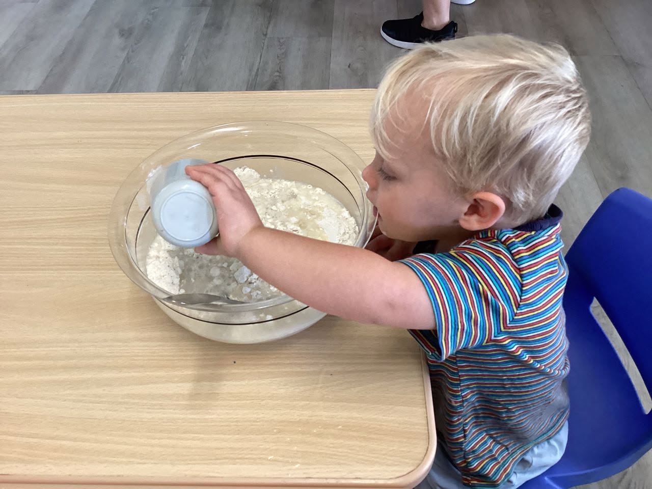 Children participating in cooking activity in kitchen