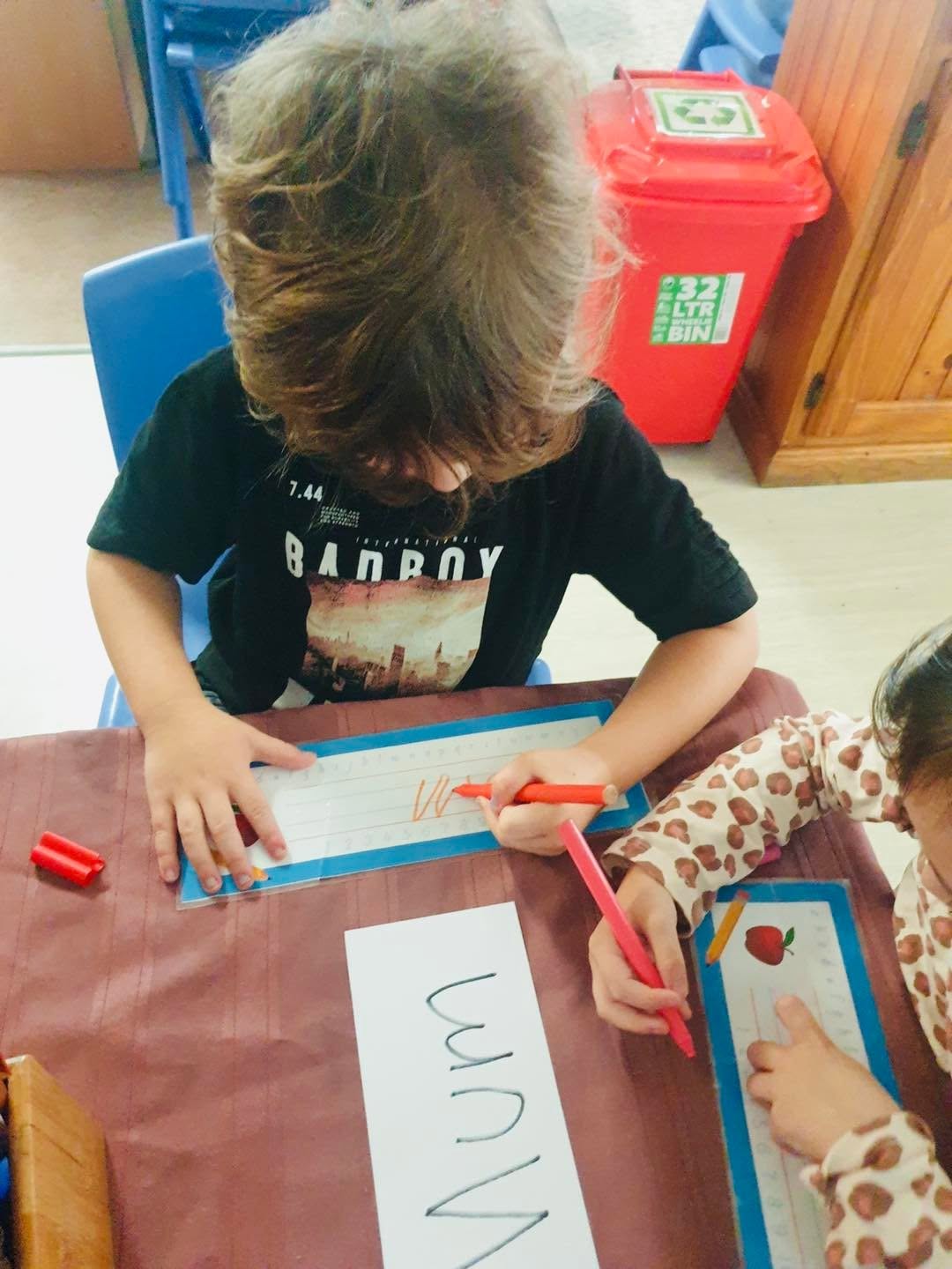 Young children making Mother’s Day crafts and artwork