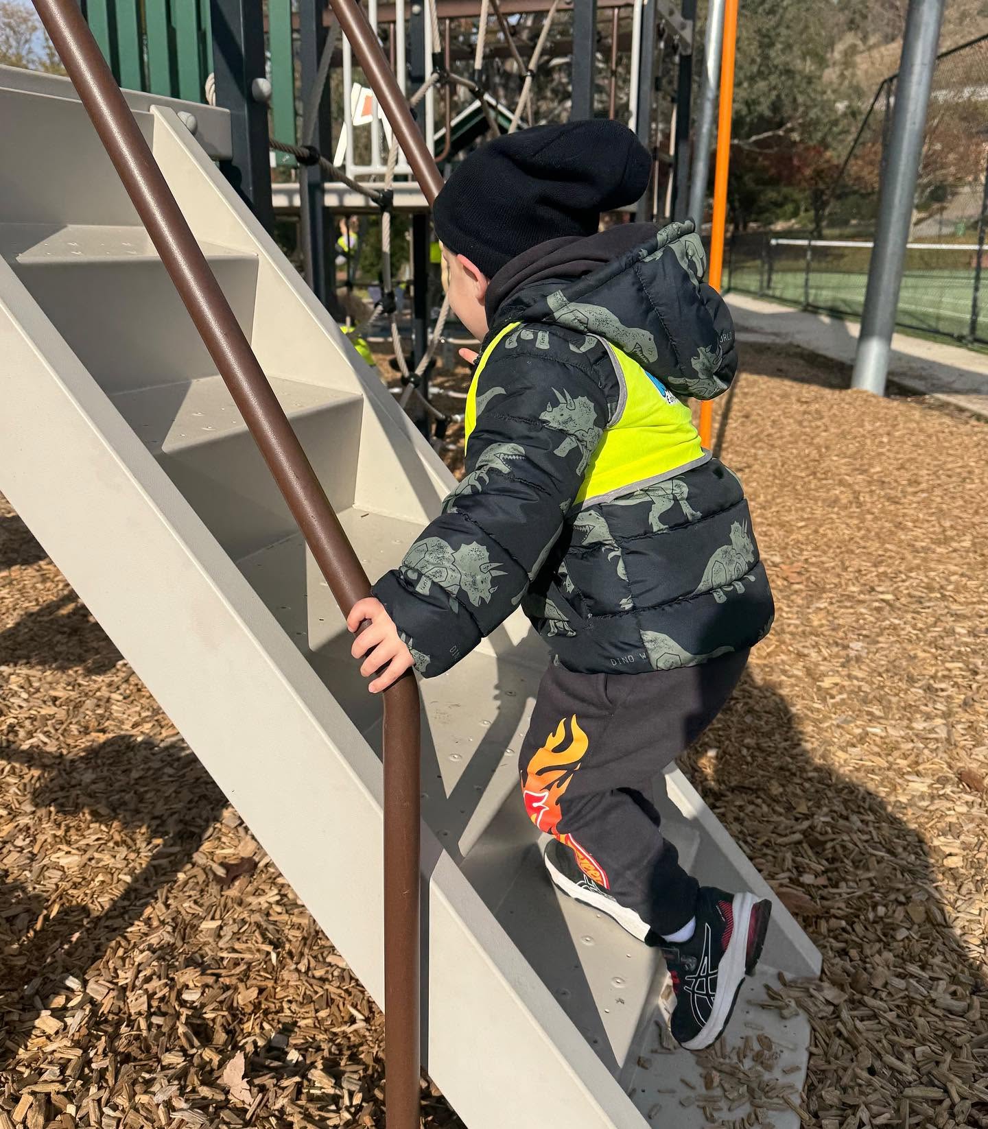 Child dressed warmly enjoying outdoor play during winter