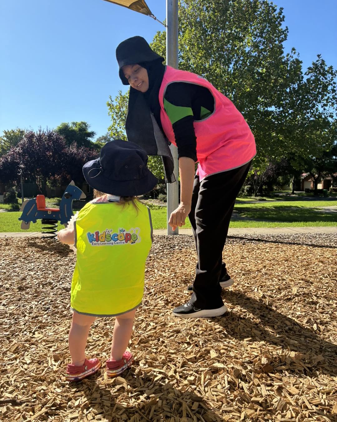 Parent saying goodbye to child at childcare during morning drop off