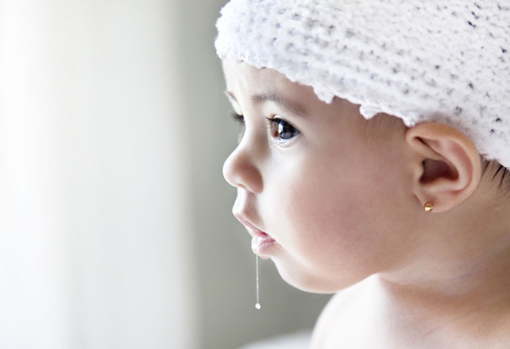 Baby during a normal drooling and teething stage