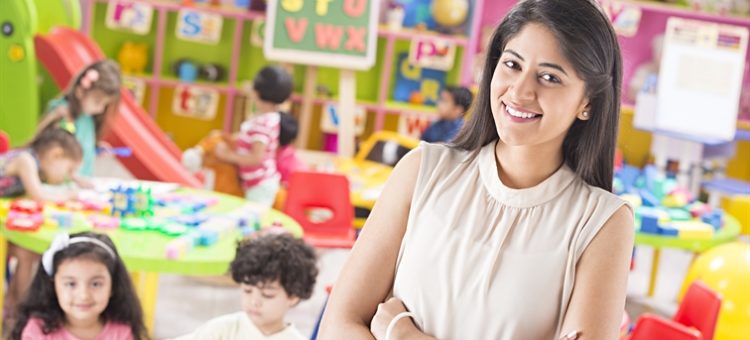 Educator engaging children in a classroom learning activity